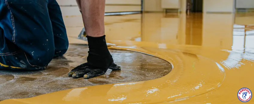 BCC - Worker coating floor with epoxy resin