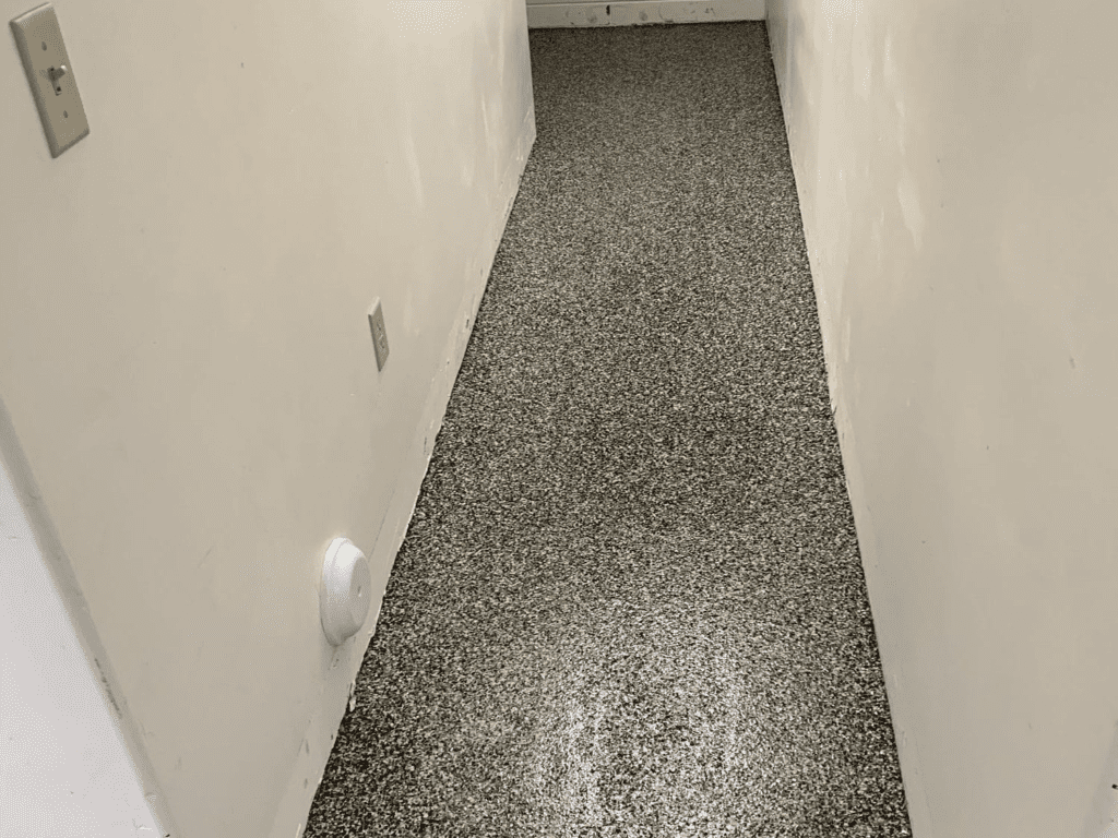 A fully coated and polished concrete floor of the hallway in the basement.