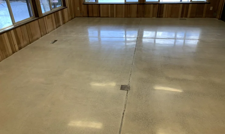 A fully polished concrete floor with wooden walls.