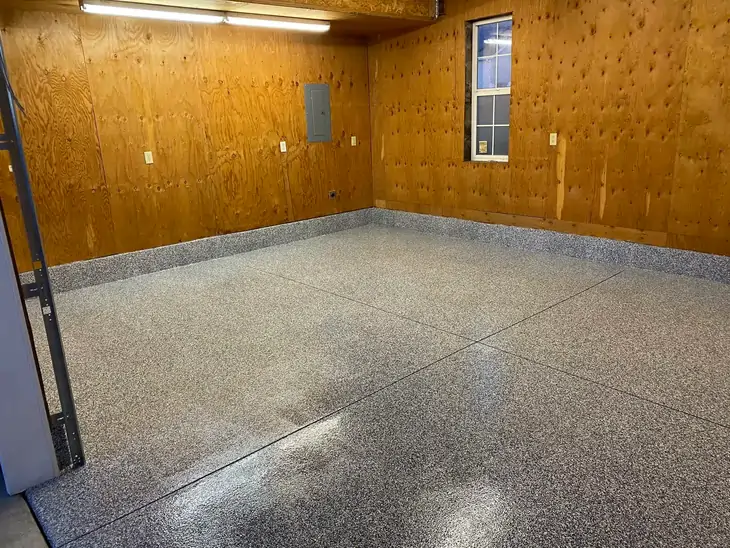An after photo of an empty brown room with a professionally coated and polished concrete tiles.