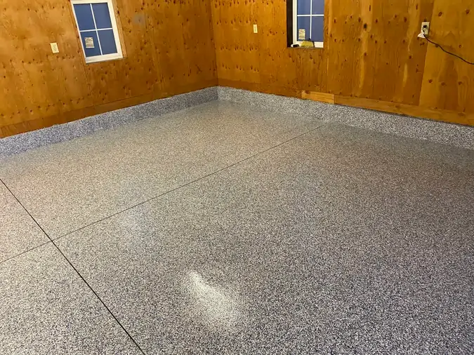 An after photo of a brown room with a coated and polished concrete tiled floor.