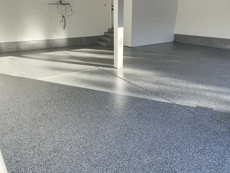 An after photo of a room with white walls and a fully coated and polished floor. 