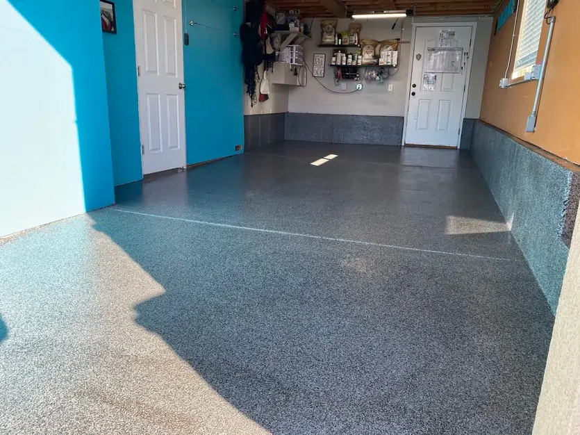 An after photo of a garage after being professionally coated with concrete and polished.