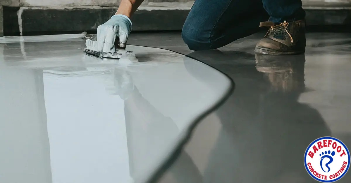 A person applying epoxy floor coating